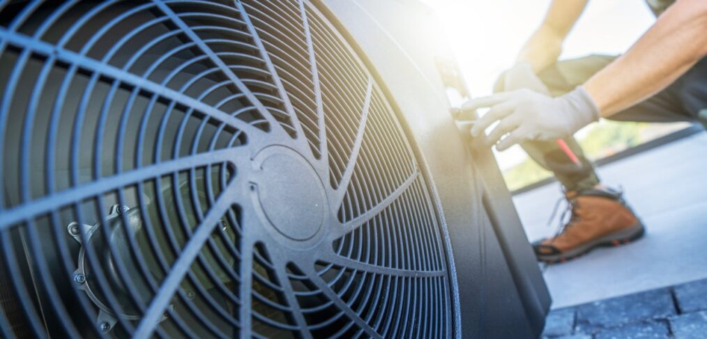 Engineer servicing a rooftop air conditioning unit