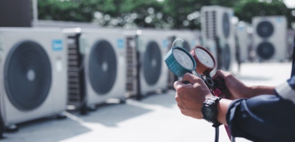 Technician is checking air conditioner ,measuring equipment for filling air conditioners.